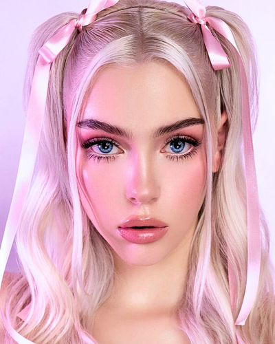 photo of a woman with blonde pigtails and doll like makeup